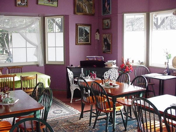 A photo of the main dining area showing several paintings on the walls
