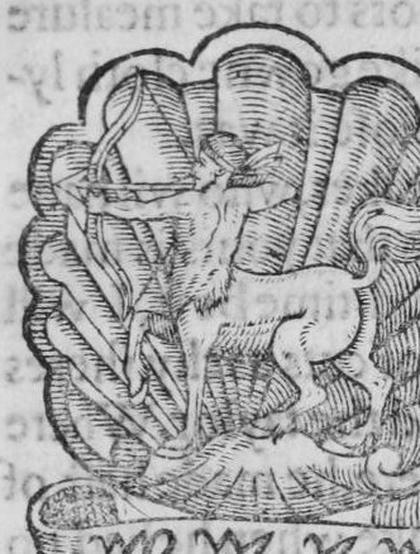 A badge: a sagittary (a centaur with bow) within an escallop, with a scroll.